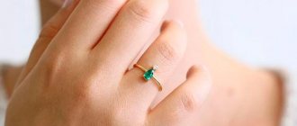 ring with emerald on hand