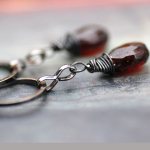 Earrings with dark red stone and wire